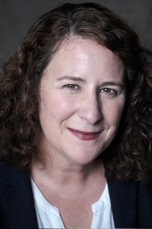 Photo of Karen Kelleher a white woman with curly brown hair