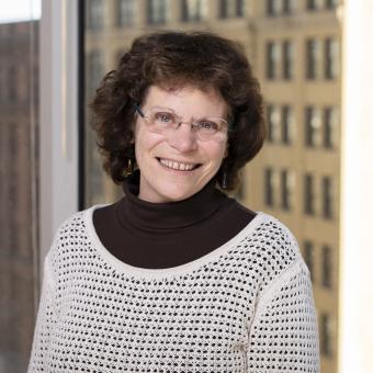 A woman standing in front of a window