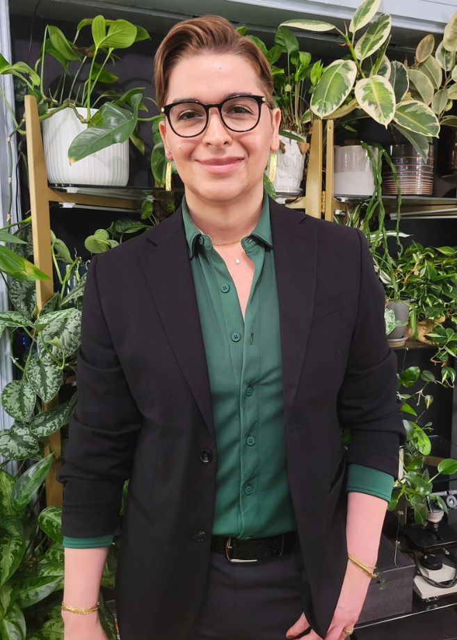 a woman standing in front of plants