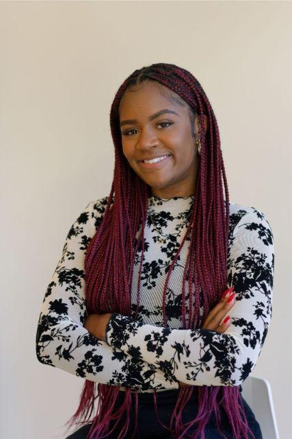 a smiling woman with crossed arms