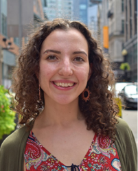 A smiling woman on a city street