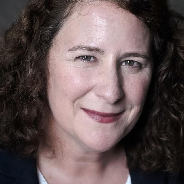 Photo of Karen Kelleher a white woman with curly brown hair