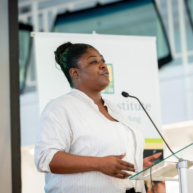 A person speaking at a podium.