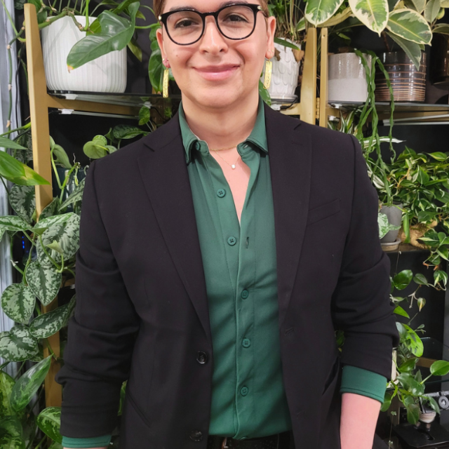 a woman standing in front of plants
