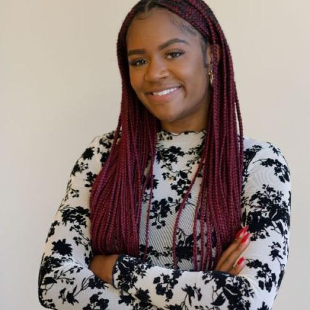 a smiling woman with crossed arms
