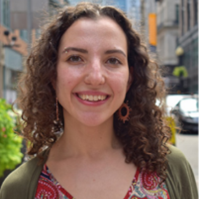 A smiling woman on a city street